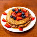 Vanilla protein pancakes finished on a white plate &ndash; easy high-protein breakfast recipe