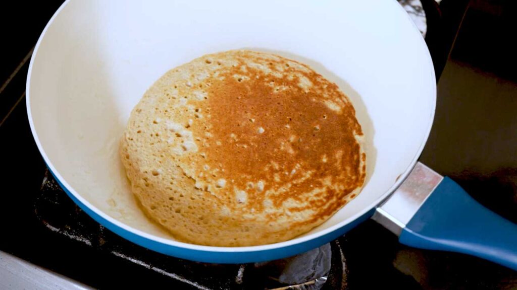 Vanilla protein pancakes with fork bite – high-protein breakfast showing fluffy interior texture
