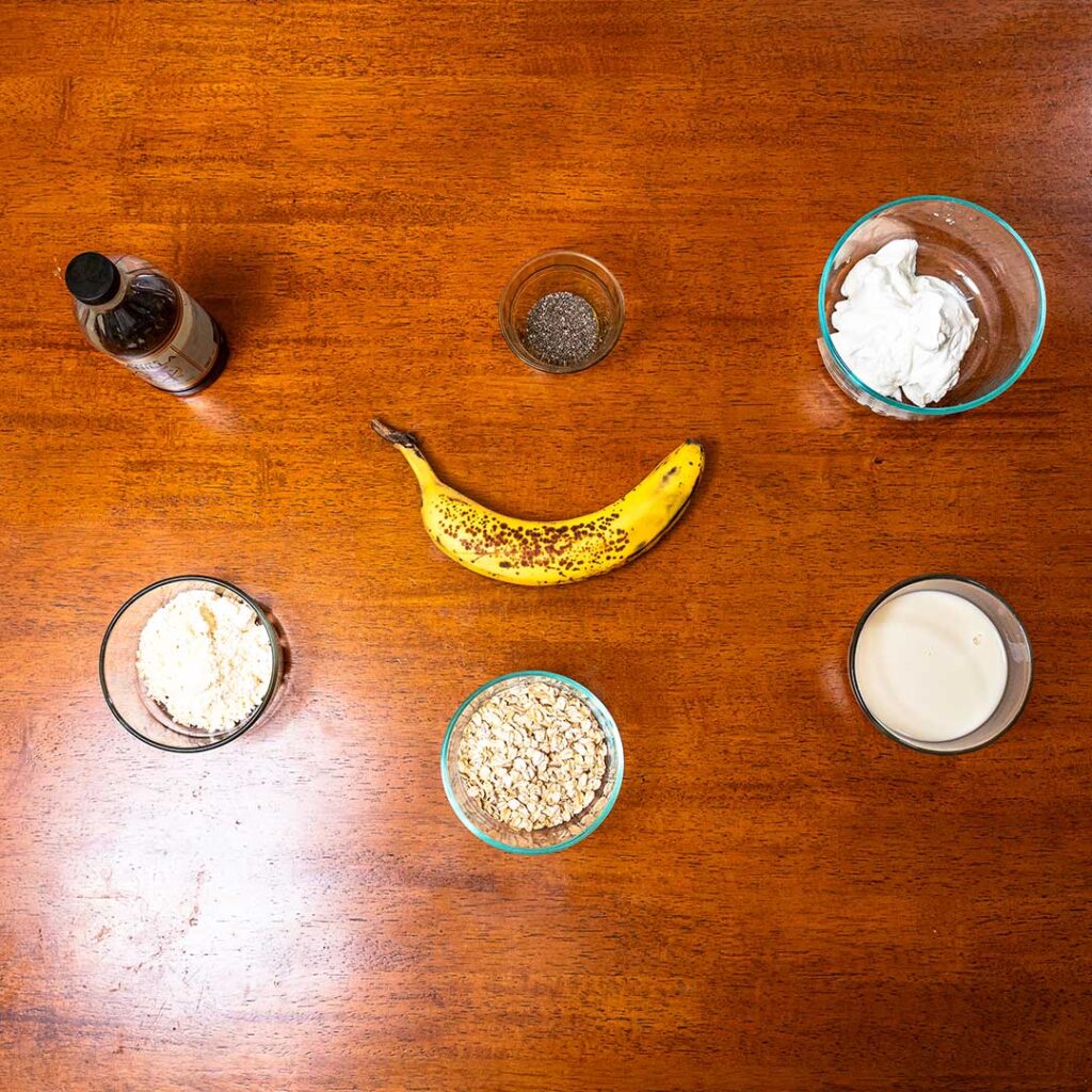 Overnight oats ingredients – oats, banana, protein powder, milk for high-protein breakfast recipe
