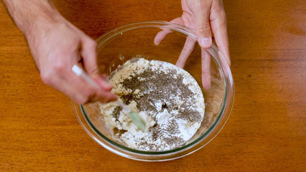 Making banana cream overnight oats – step 1: mixing oats, protein powder and milk in jar