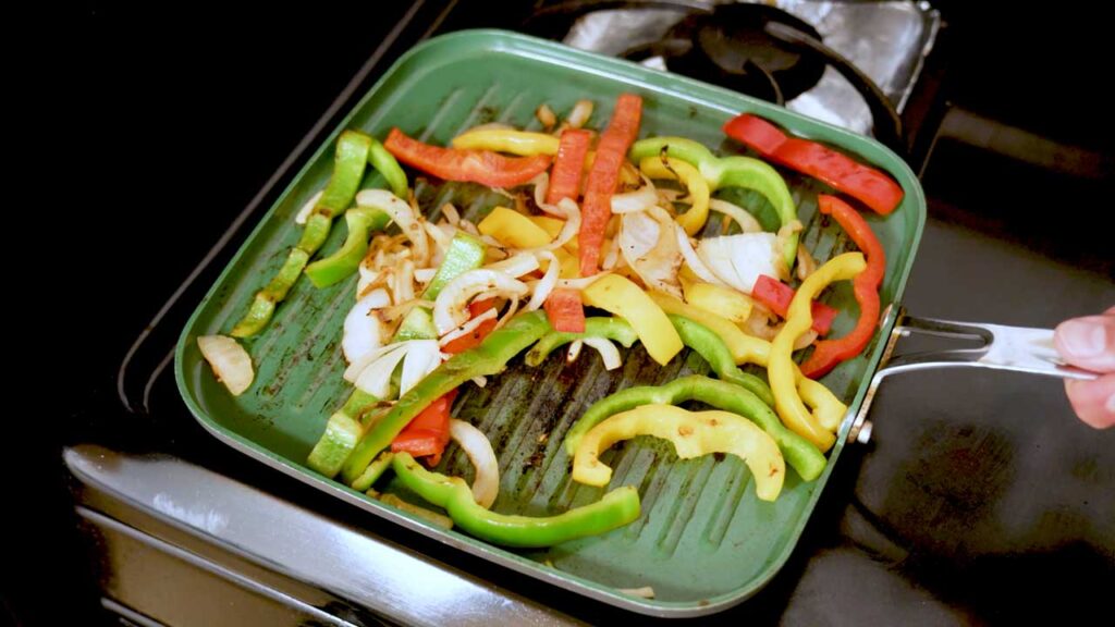 Making chicken fajitas – step 2: cooking chicken and peppers in sizzling skillet