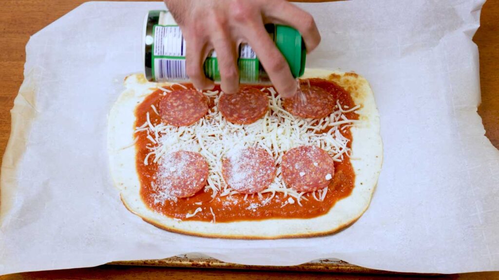Making cottage cheese flatbread pizza  step 3: adding sauce, cheese and toppings to crust