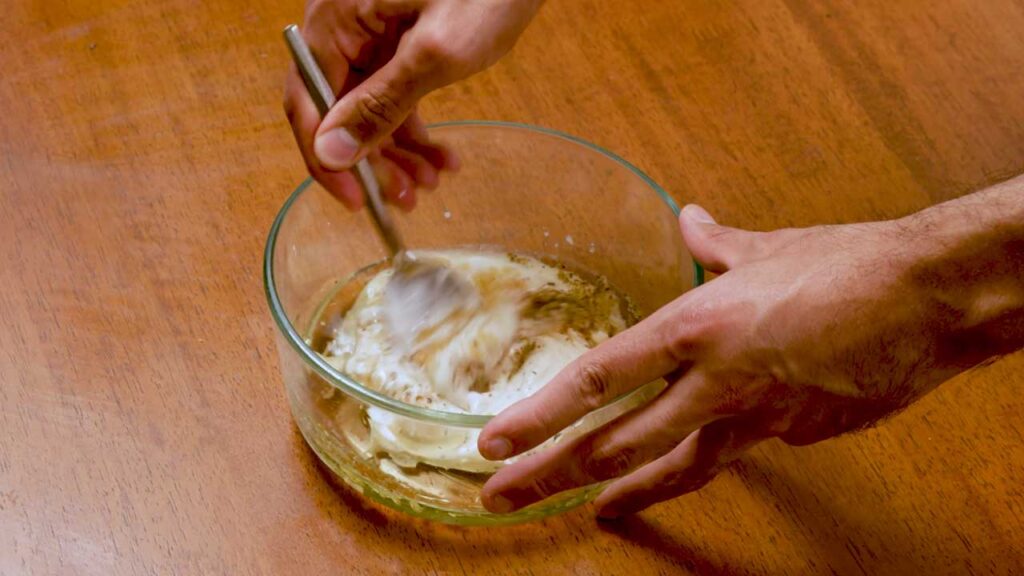 Making dense bean salad – step 3: tossing bean salad with dressing before serving