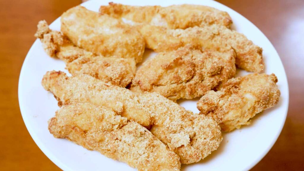 Almond flour parmesan chicken tenders flat lay – high-protein baked chicken with dipping sauce