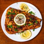 Cajun salmon &ndash; high-protein dinner with cajun seasoning and lemon wedge