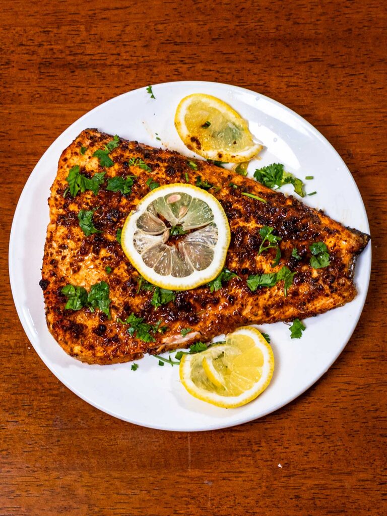 Cajun salmon &ndash; high-protein dinner with cajun seasoning and lemon wedge