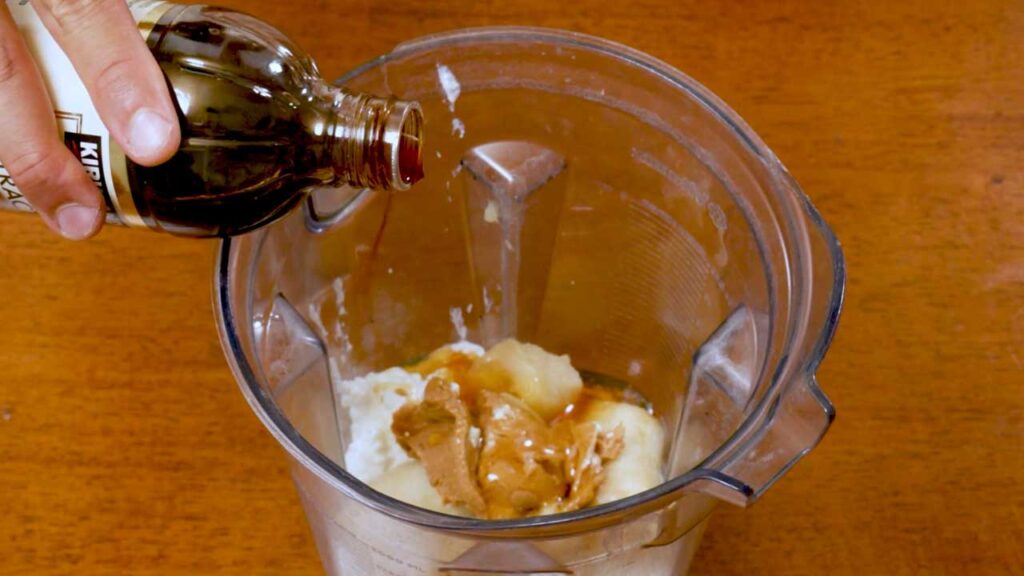Cottage cheese peanut butter banana ice cream &ndash; scooping ice cream into a serving bowl