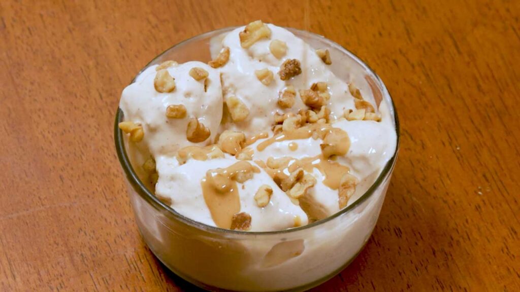 Cottage cheese peanut butter banana ice cream &ndash; overhead shot of dessert in a glass bowl