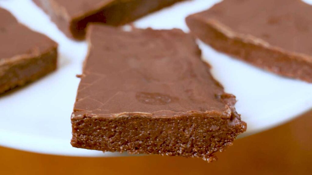 No bake chocolate protein bars flat lay &ndash; high-protein snack with rich chocolate coating on plate