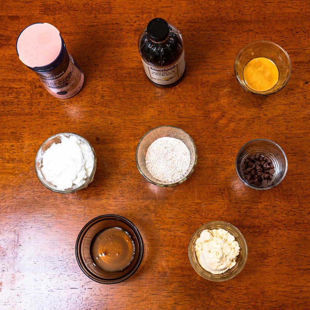Protein cookie dough ingredients &ndash; oats, protein powder, peanut butter, chocolate chips