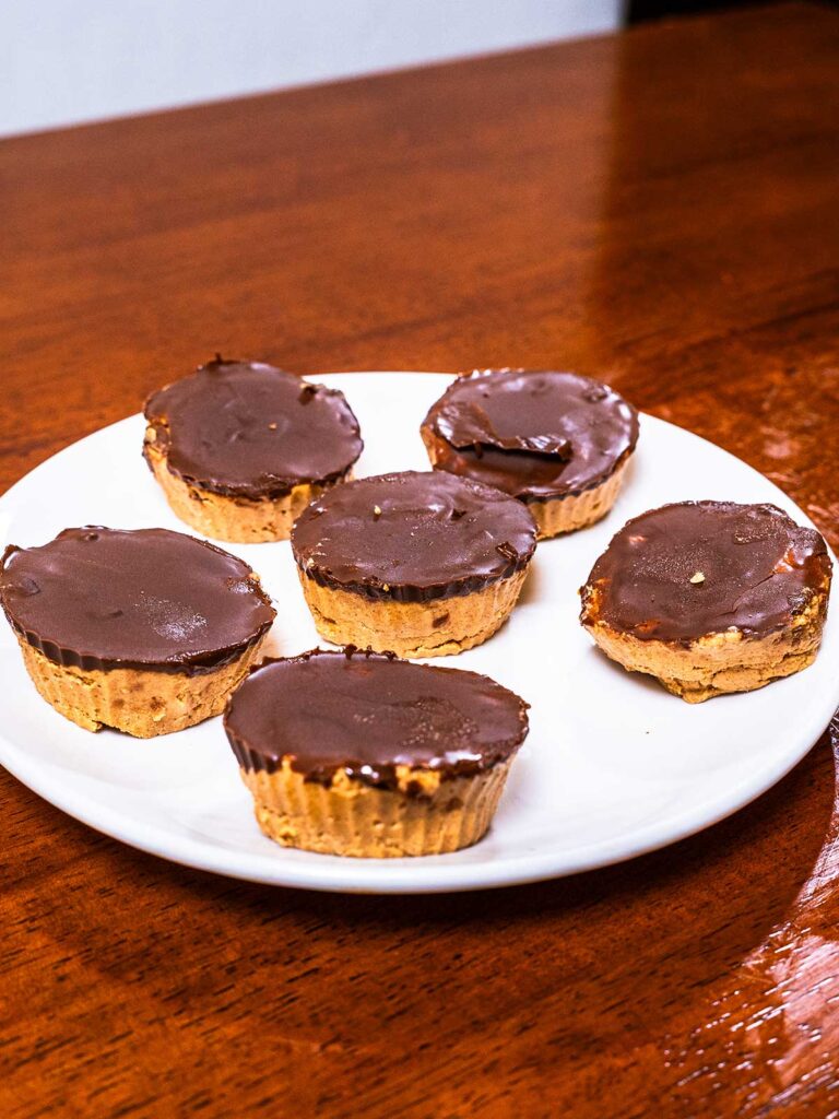 Protein peanut butter cups hero shot -- high-protein chocolate peanut butter cups on plate