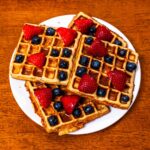 Protein waffles hero shot -- stacked high-protein waffles with toppings on plate