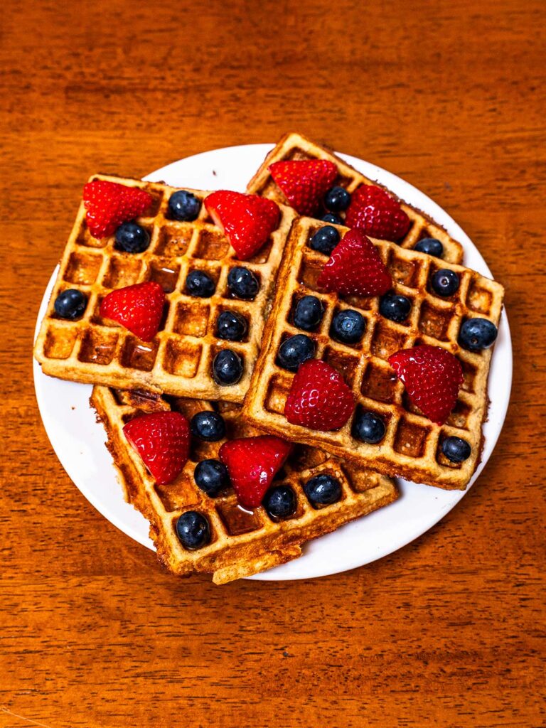 Protein waffles hero shot -- stacked high-protein waffles with toppings on plate