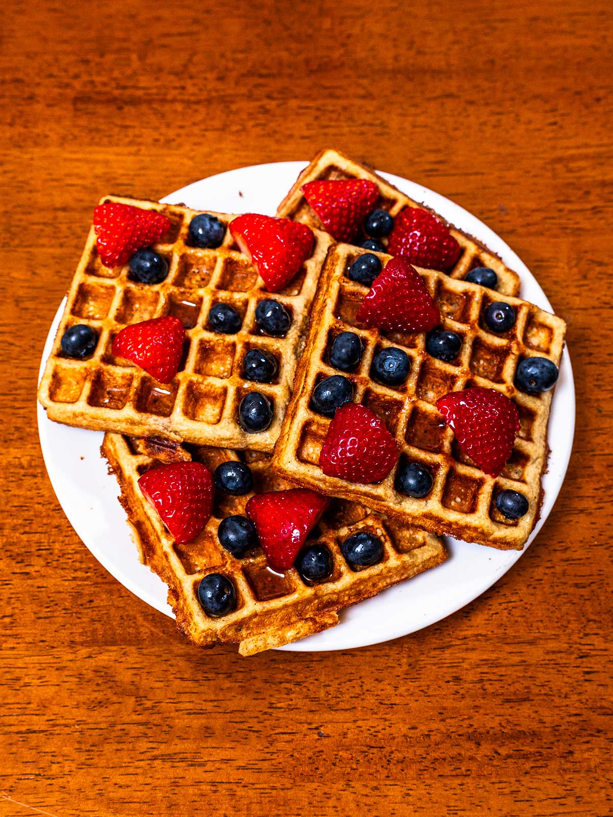 Protein waffles hero shot -- stacked high-protein waffles with toppings on plate