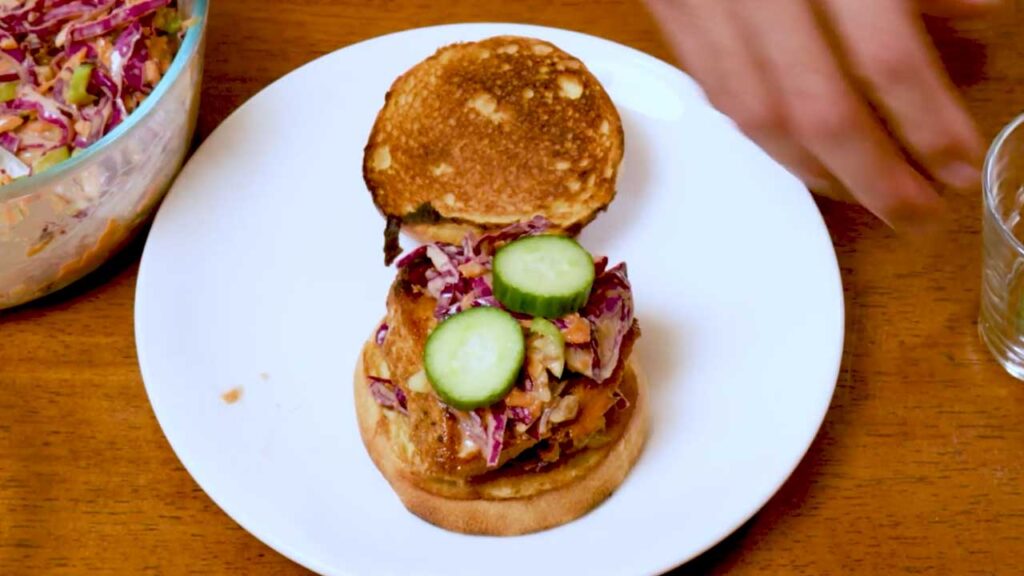 Spicy Asian chicken sandwich angled shot – high-protein lunch recipe with Asian slaw