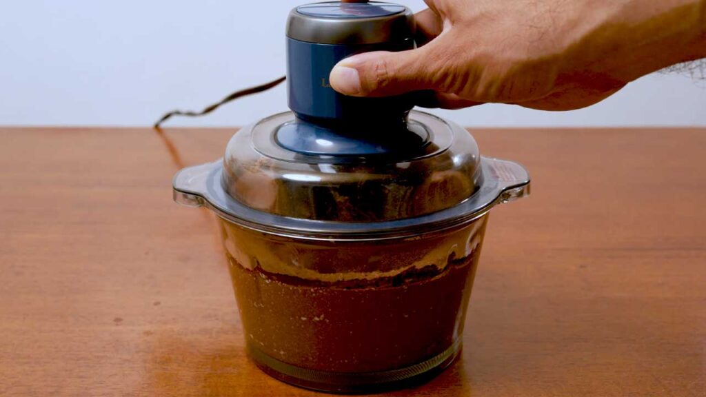 How to make cottage cheese chocolate ice cream &ndash; step showing frozen ice cream being stirred