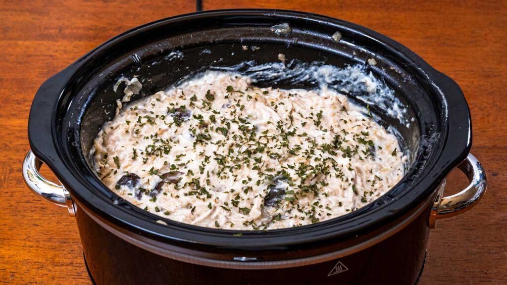 How to make slow cooker chicken and rice &ndash; step showing chicken being prepared for slow cooker