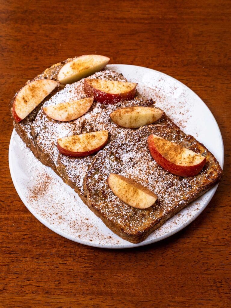 slice of apple cinnamon protein french toast with apple pieces