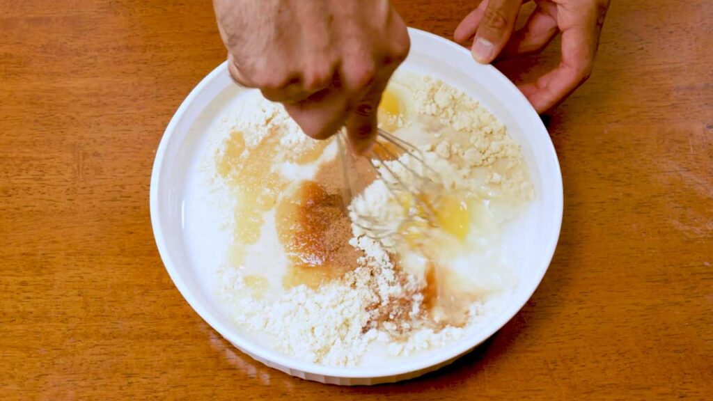 Making apple cinnamon protein french toast, whisking eggs, protein powder, and vanilla