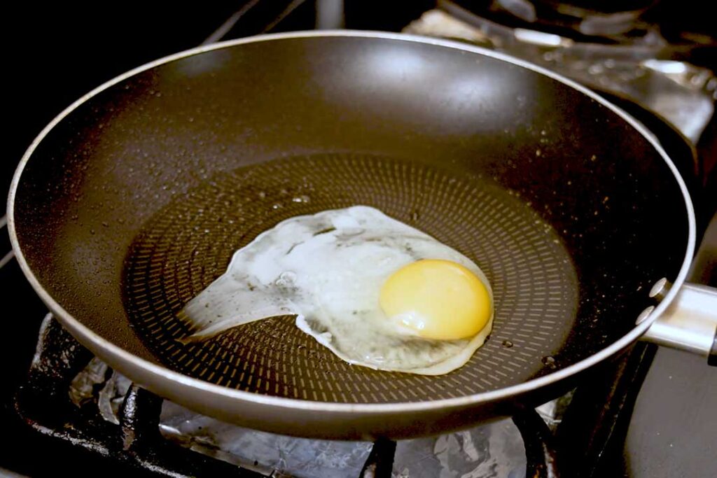 Fried egg in a non-stick skillet, an easy high protein breakfast