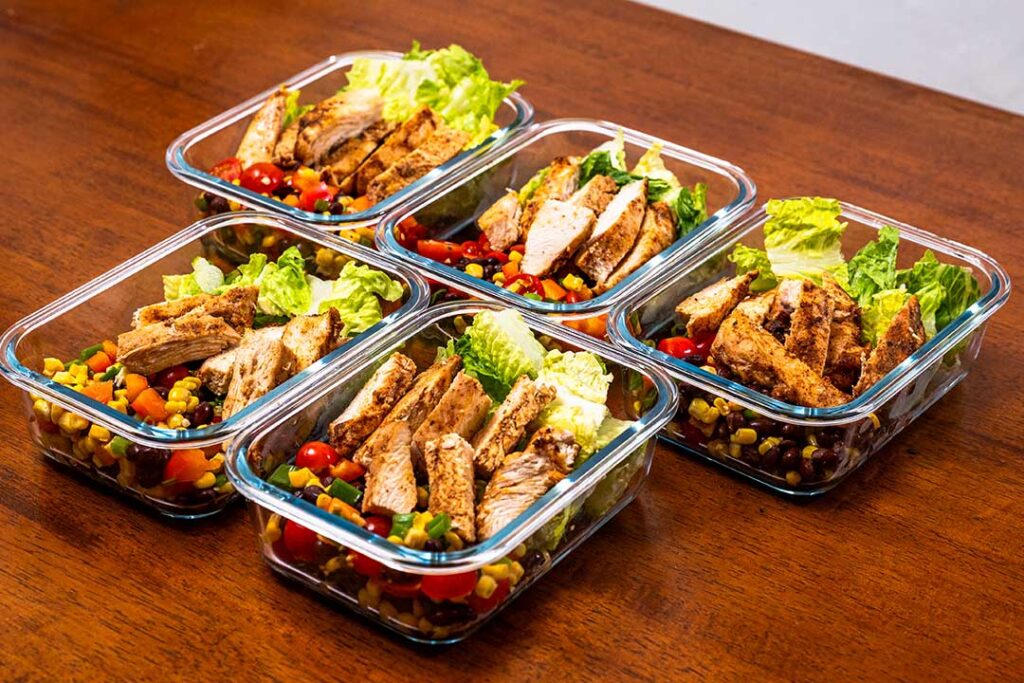 High protein chicken salad meal prep, grilled chicken, black beans, corn, and vegetables