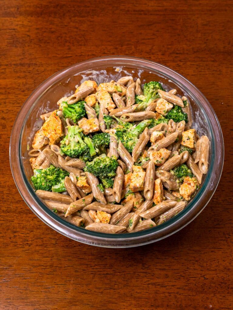 Cottage cheese chicken alfredo pasta with broccoli in a glass bowl, a high-protein dinner