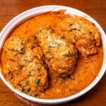Marry me chicken with spinach and parmesan in a white dish, a high-protein dinner
