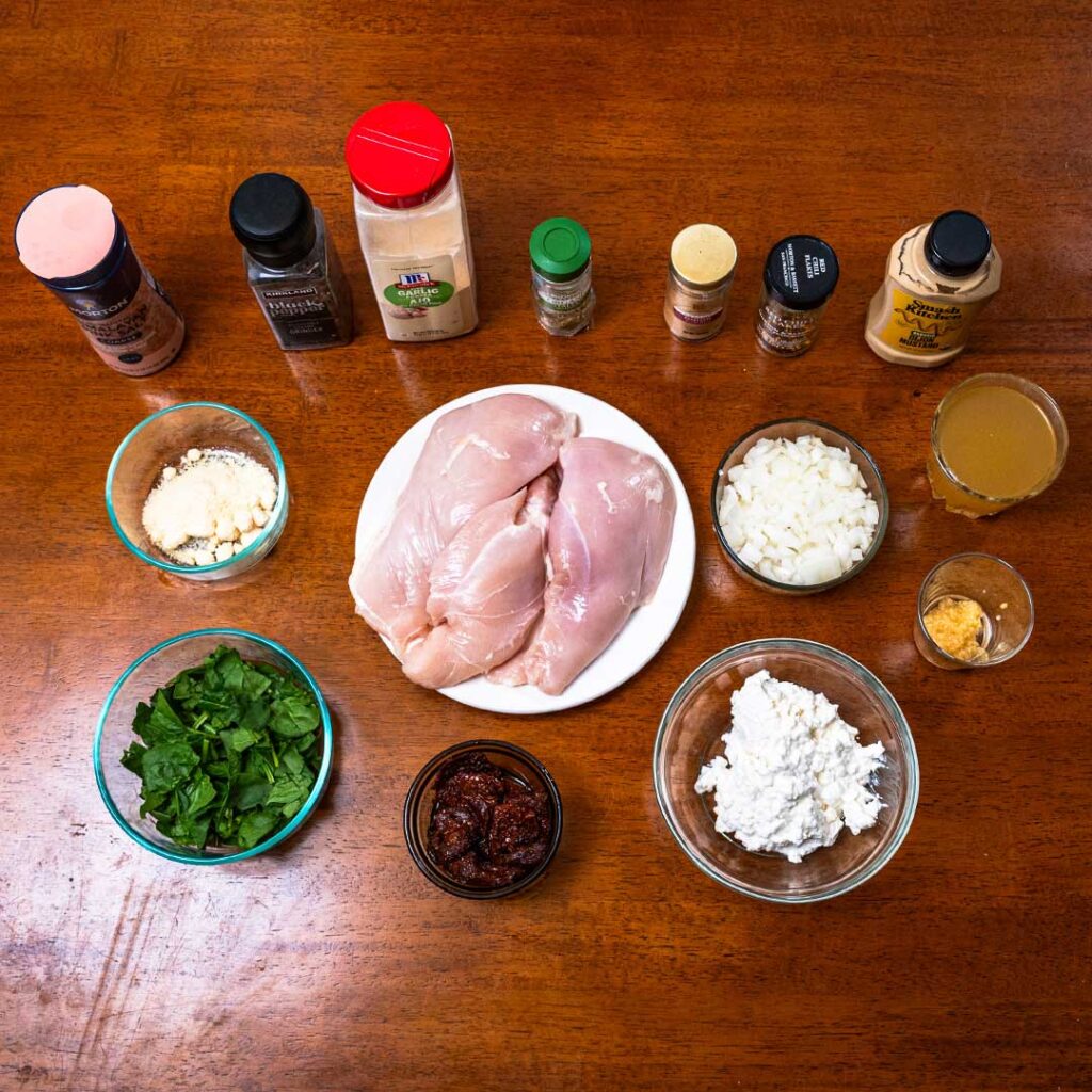 Marry me chicken ingredients, chicken breast, spinach, onions, cottage cheese, and sun-dried tomatoes