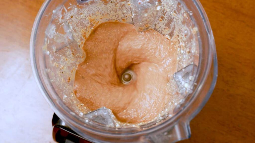 Smooth orange marry me chicken sauce blended in a blender, overhead view