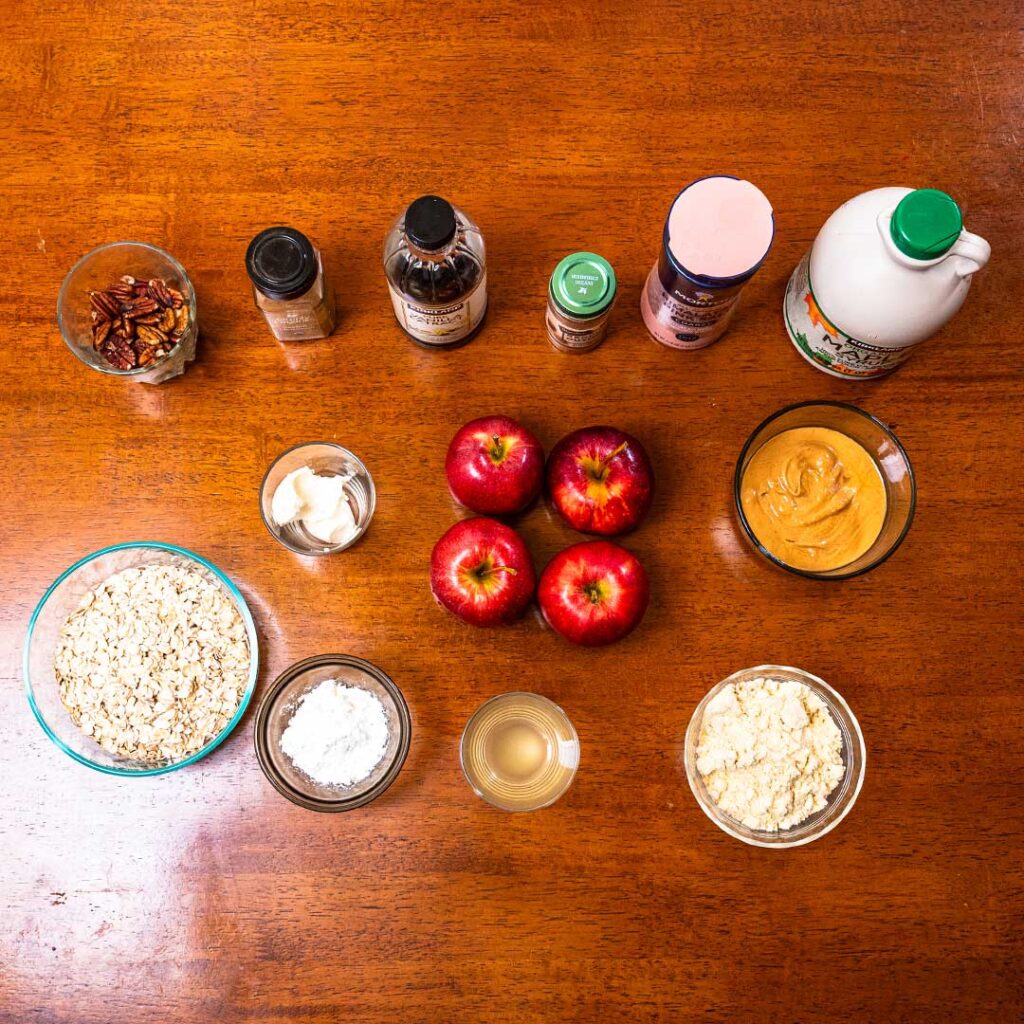 High-protein apple crisp ingredients, apples, oats, cottage cheese, peanut butter, and pecans