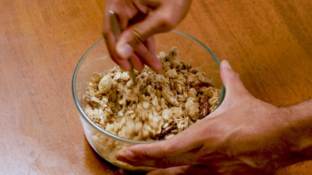 Mixing oats, pecans, and cottage cheese for the apple crisp topping