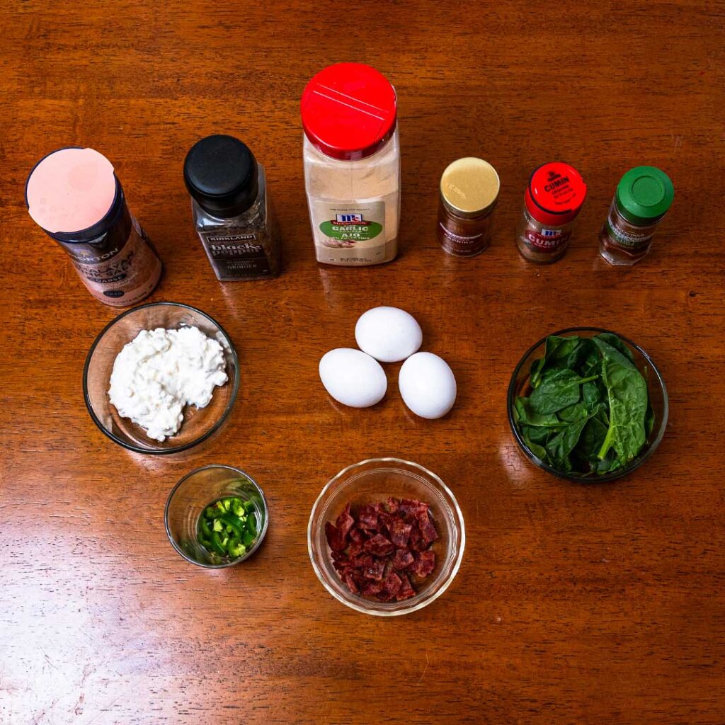 Tex-mex scrambled eggs ingredients, eggs, cottage cheese, spinach, jalapeno, and spices