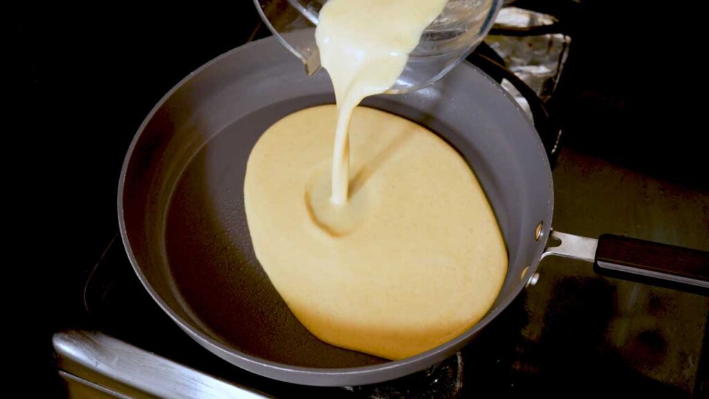 Pouring the blended egg and cottage cheese mixture into a skillet
