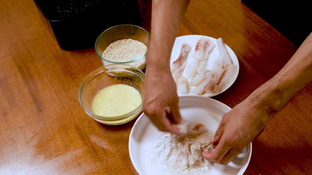 How to bread fish sticks, dredging fish strips in flour, egg, and panko crumbs
