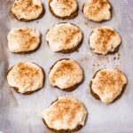 Baked gingerbread protein cookies with white icing, dusted with cinnamon