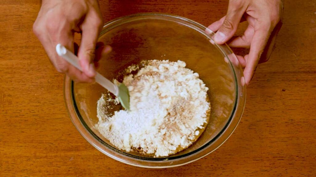 Mixing gingerbread cookie dough in a glass bowl, step by step