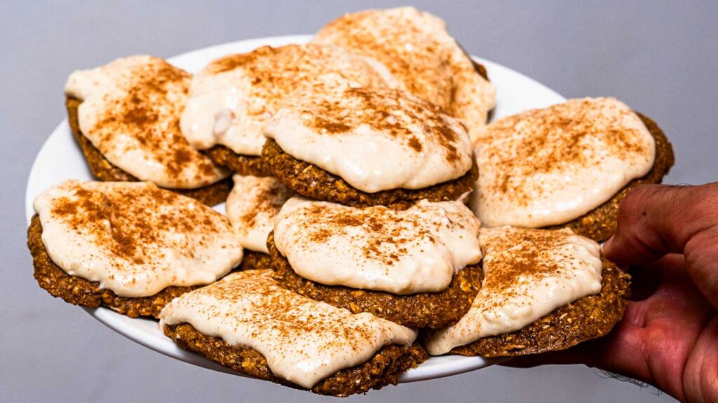 A plate of frosted gingerbread protein cookies, a high-protein treat